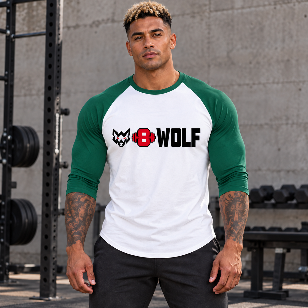 AI-generated original adult tattooed male bodybuilder wearing White Kelly W8WOLF Bold Logo Three Quarter Sleeve Raglan at an urban strength gym. Kelly green sleeve color matched to supplier reference, original black wolf red eyes red barbell8 thick WOLF front print retained. Pants styling only.