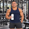 AI-generated original adult bodybuilder model in a bodybuilding gym holding W8WOLF Essentials 32 oz Straw-Lid Water Bottle with original wolf, red barbell 8 and thick WOLF print. All four supplier bottle views retained; training clothing is styling only.