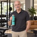 AI-generated original adult model visualization holding Mint Green W8WOLF Essentials 22 oz Copper-Insulated Training Bottle with original wolf, red barbell 8 and WOLF print. All twelve supplier bottle images retained; clothing is styling only.