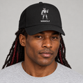 AI-generated original adult model visualization wearing Black W8WOLF Iron Curl Frame Cap with red-eyed curl wolf and separate white wordmark; original supplier Black cap image retained. Other cap colors remain available separately.