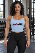 AI-generated original adult tattooed female bodybuilder wearing Solid Baby Blue Blend W8WOLF Essentials Womens Micro Rib Tank in an urban gym. Actual thin straps rib texture and original black wolf red eyes red barbell8 WOLF front print retained. Leggings styling only; other colors preserved.