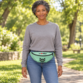 AI-generated original adult model visualization wearing W8WOLF Mint Monogram Training Waist Pack with original black red-eyed wolf, red barbell 8 and WOLF details. Original supplier image retained. Gray sweatshirt and jeans are styling only.