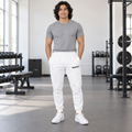 AI-generated original adult model visualization wearing W8WOLF Mono Fleece Joggers in White with black uppercase W8WOLF left-thigh wordmark; all four supplier garment views retained. Gray shirt and white shoes are styling only.