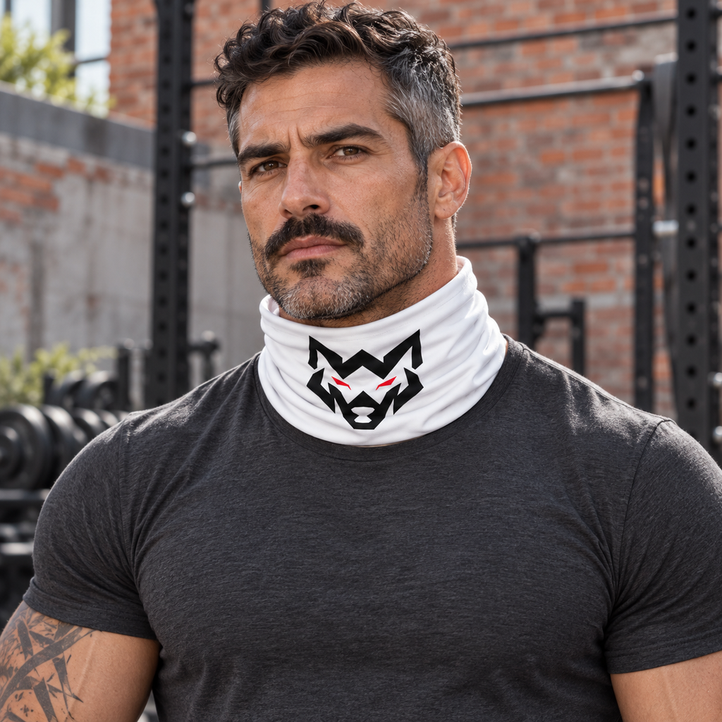 AI-generated original adult tattooed male bodybuilder wearing W8WOLF Wolf Emblem Neck Gaiter White around neck below chin in an urban gym. Actual white tubular fabric and original black wolf red eyes artwork retained with natural folds. Shirt styling only.
