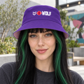 AI-generated original adult model visualization wearing W8WOLF Purple Pack Reversible Bucket Hat on its purple logo side; original supplier views of purple outside and pale-pink wordmark reverse retained.