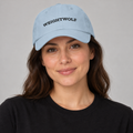 AI-generated adult model visualization wearing the Light Blue WEIGHTWOLF Serif Classic Dad Hat with black front print; original supplier images show all five available colors.