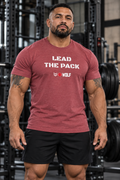 AI-generated original adult tattooed male powerlifter wearing Burgundy Heather W8WOLF Lead the Pack Stencil Heather Tee in an urban strength gym. Actual white stencil slogan and original wolf red barbell8 WOLF print retained. Shorts styling only; other color supplier images retained.