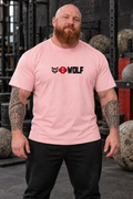 AI-generated original adult tattooed strongman wearing W8WOLF Classic Gym Tee Light Pink in an urban gym. Actual pale pink cotton cut black original wolf red barbell8 and thick WOLF centered print retained. Pants styling only.