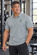 AI-generated original adult male strongman wearing W8WOLF Iron Curl Lead the Pack Polo Cool Heather in an urban gym. Actual small red-eyed curling wolf chest emblem, black sleeve W8WOLF, three-button polo and color retained; back slogan shown in supplier photo. Trousers styling only.