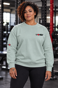 AI-generated original adult female powerlifter wearing W8WOLF Signature Crewneck Agave in an urban gym. Actual pale sage sweatshirt cut small black wolf red eyes red barbell8 WOLF left chest and right sleeve wolf8 retained. Pants styling only.