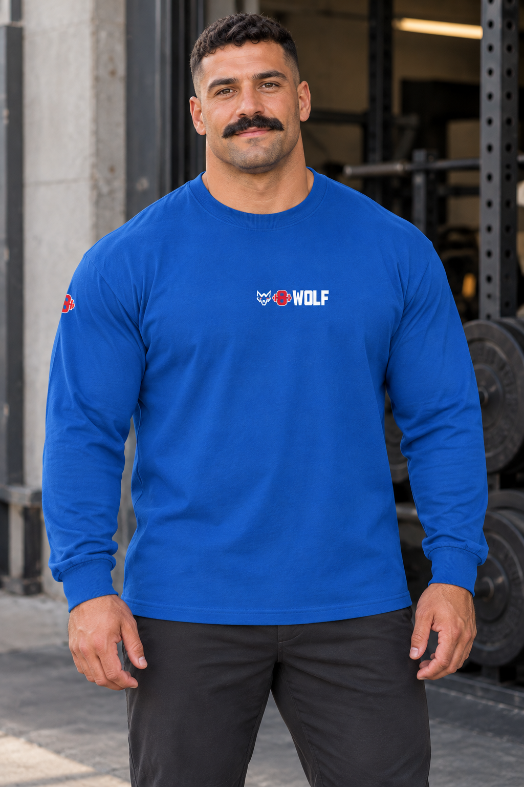 AI-generated original adult male powerlifter wearing W8WOLF Signature Long Sleeve Royal outside an urban gym. Actual royal blue cotton cuffed sleeves small centered white wolf red eyes red barbell8 WOLF and right sleeve mark retained. Pants styling only.