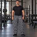 AI-generated original adult male model wearing WEIGHTWOLF Grayscale Overload cotton wide-leg pants with original wolf right thigh and red-outlined wordmark left thigh. Shirt and shoes styling only.